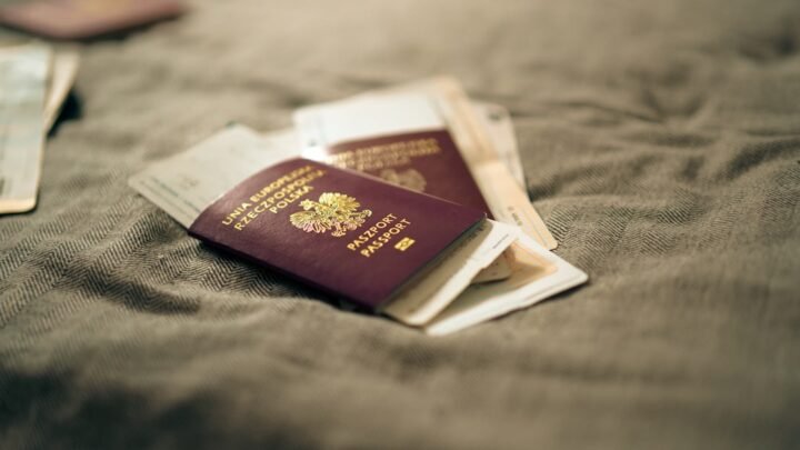 Two passports resting on printed travel documents