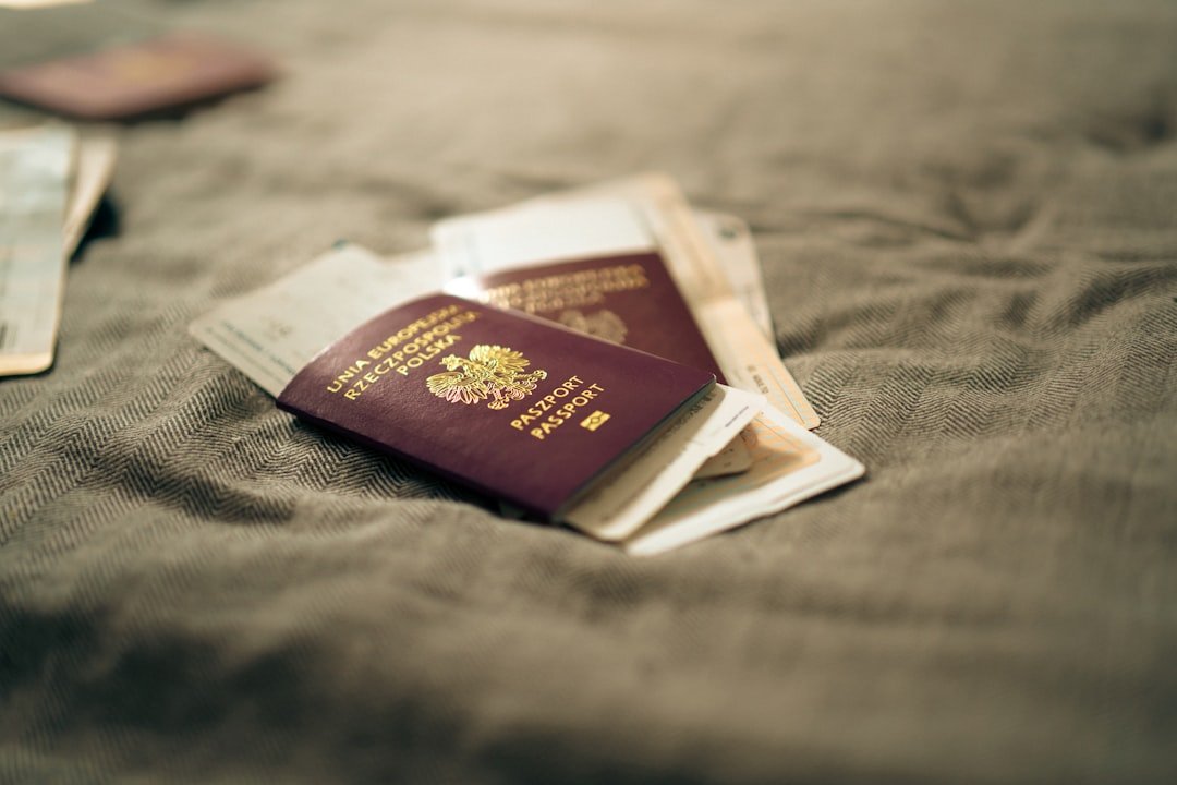Two passports resting on printed travel documents